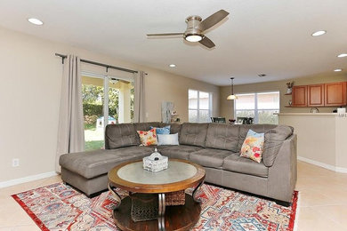 Inspiration for an eclectic open concept porcelain tile and beige floor living room remodel in Other with beige walls