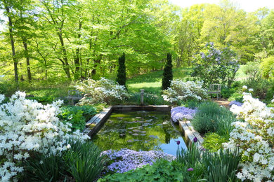 Photo of a large traditional partial sun backyard mulch landscaping in Providence.