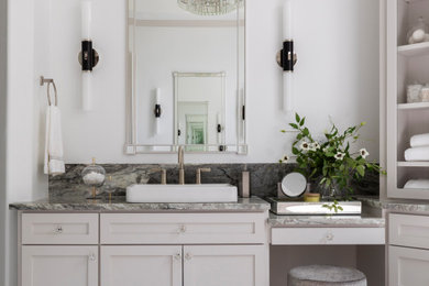 Mid-sized trendy marble floor, beige floor, double-sink and tray ceiling bathroom photo in Houston with shaker cabinets, gray cabinets, a two-piece toilet, white walls, a vessel sink, granite countertops, a hinged shower door, gray countertops and a built-in vanity
