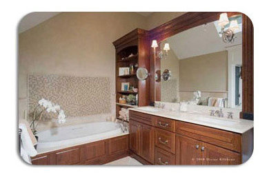 Inspiration for a timeless beige tile and glass tile bathroom remodel in Other with raised-panel cabinets, medium tone wood cabinets and limestone countertops