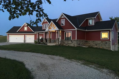 Large farmhouse red two-story wood exterior home photo in Omaha with a shingle roof
