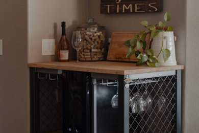 Home bar - rustic home bar idea in San Diego with wood countertops