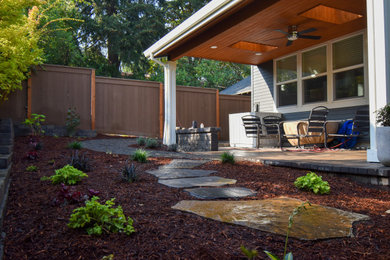 Photo of a mid-sized partial sun backyard concrete paver flower bed in Portland.