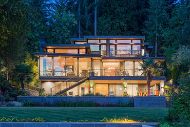 Midcentury three-storey glass house exterior in Seattle.