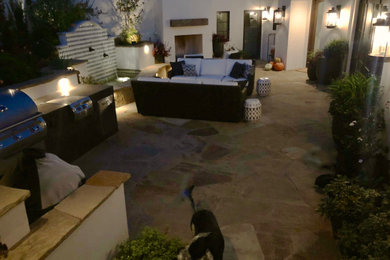 Inspiration for a large modern courtyard patio in San Francisco with an outdoor kitchen and natural stone pavers.