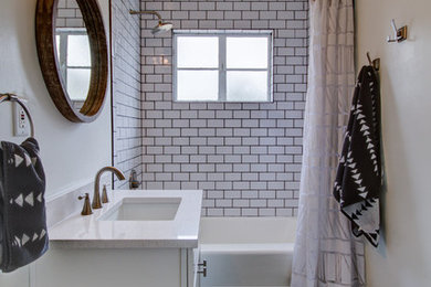 Small traditional kids bathroom in Phoenix with shaker cabinets, white cabinets, an alcove tub, a shower/bathtub combo, white tile, subway tile, grey walls, porcelain floors, an undermount sink and quartzite benchtops.