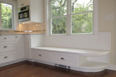 Example of a large minimalist l-shaped dark wood floor and brown floor open concept kitchen design in Philadelphia with a drop-in sink, recessed-panel cabinets, white cabinets, marble countertops, gray backsplash, ceramic backsplash, stainless steel appliances and an island