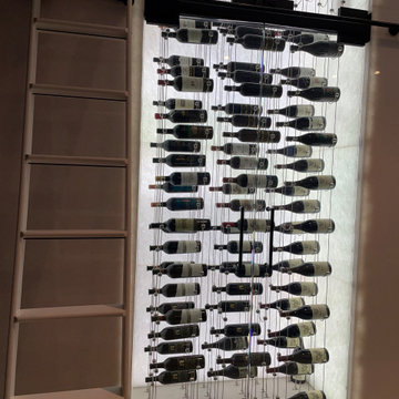 Frameless Glass Doors To Let the Modern Wine Cellar Lighting Pass Through Freely