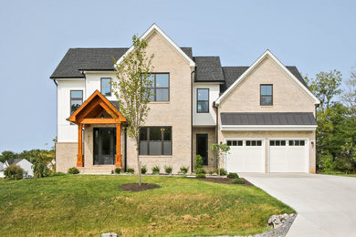 Example of a large classic three-story brick house exterior design in DC Metro with a black roof