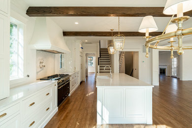Kitchen - french country kitchen idea in DC Metro with shaker cabinets, white cabinets, quartz countertops, black appliances, an island and white countertops