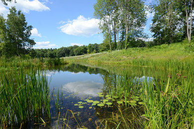 Inspiration for a huge full sun hillside water fountain landscape in New York for summer.
