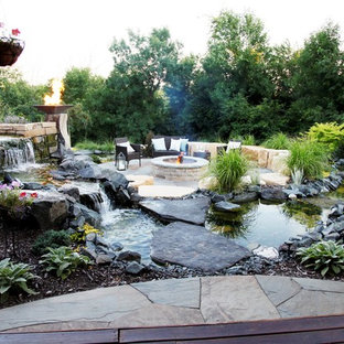 Design ideas for a large transitional partial sun backyard stone formal garden in Minneapolis with a fire pit for summer.