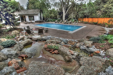 Example of a mid-sized trendy backyard rectangular lap pool fountain design in Denver