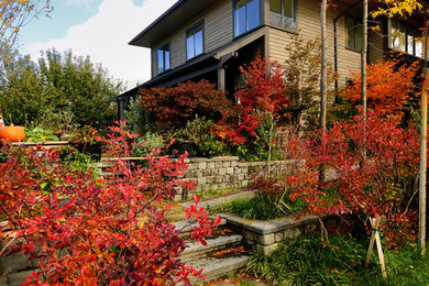 Example of a large classic beige three-story wood exterior home design in Seattle with a shingle roof