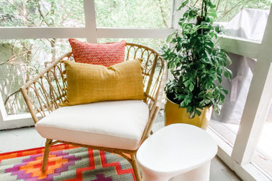 This is an example of an eclectic screened-in back porch design in Atlanta.