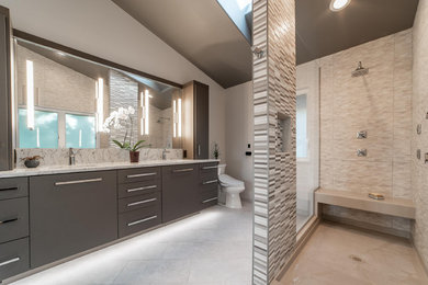 Trendy master beige tile and porcelain tile porcelain tile bathroom photo in Seattle with flat-panel cabinets, brown cabinets, a bidet, an undermount sink and marble countertops