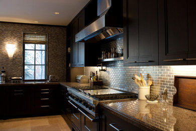 Enclosed kitchen - large traditional l-shaped travertine floor and beige floor enclosed kitchen idea in Other with recessed-panel cabinets, black cabinets, granite countertops, metallic backsplash, metal backsplash, stainless steel appliances and an island