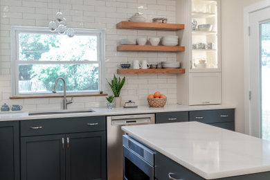 Transitional l-shaped separate kitchen in St Louis with an undermount sink, shaker cabinets, green cabinets, quartz benchtops, white splashback, subway tile splashback, stainless steel appliances, light hardwood floors, with island and white benchtop.