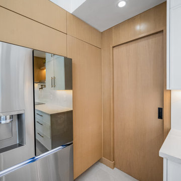 Hidden Pantry Entry Next to Seamless Refrigerator Paneling