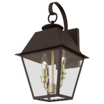 Livex Lighting - Wentworth 2 Light Bronze/Antique Brass, Cluster Outdoor Medium Wall Lantern - With its appealing bronze finish and clear glass, the stunning Mansfield collection will make an elegant addition to any outdoor space. Formed from solid brass & traditionally inspired, this downward hanging two-light outdoor medium wall lantern is perfect for a driveway, back porch or entry way. With superb craftsmanship and affordable price, this fixture is sure to be a timeless addition to your home.