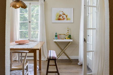 Example of a mid-sized trendy medium tone wood floor and brown floor enclosed dining room design in Los Angeles with beige walls and no fireplace