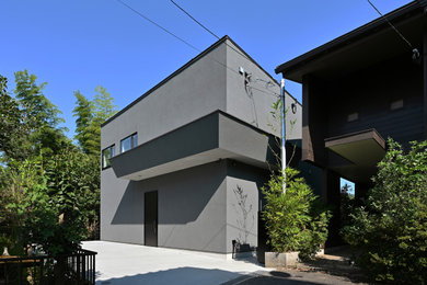東京都下にある高級な中くらいなコンテンポラリースタイルのおしゃれな家の外観 (漆喰サイディング) の写真