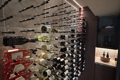 Inspiration for a small modern light wood floor wine cellar remodel in Cincinnati