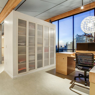 Small modern home studio in Dallas with grey walls, linoleum floors and a built-in desk.
