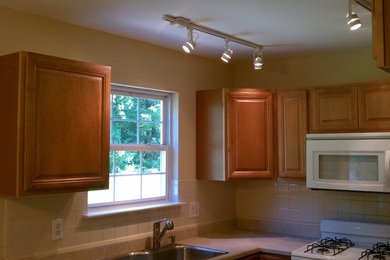 Inspiration for a kitchen remodel in Wilmington with medium tone wood cabinets, beige backsplash and white appliances