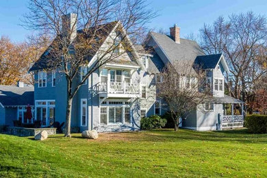 Example of a large arts and crafts blue three-story wood gable roof design in Boston