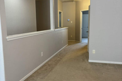 Hallway - mid-sized modern hallway idea in Houston with gray walls