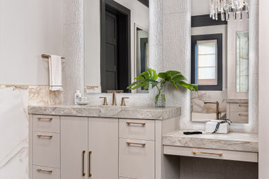 Large trendy master white tile and porcelain tile brown floor and single-sink bathroom photo in Charlotte with flat-panel cabinets, beige cabinets, gray walls, an undermount sink, quartzite countertops, a hinged shower door, beige countertops and a built-in vanity