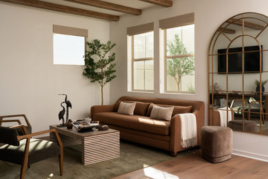 Inspiration for a mediterranean open concept medium tone wood floor, brown floor and exposed beam living room remodel in Los Angeles with white walls and a wall-mounted tv