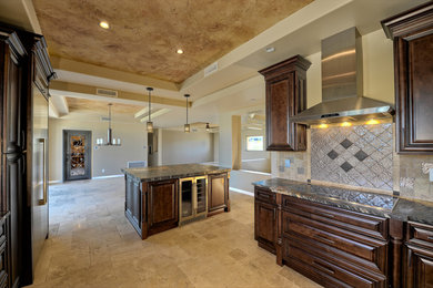 Inspiration for a modern u-shaped open concept kitchen remodel in Phoenix with beaded inset cabinets, dark wood cabinets, granite countertops, gray backsplash, stone tile backsplash, stainless steel appliances and an island