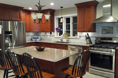 Inspiration for a mid-sized transitional l-shaped porcelain tile eat-in kitchen remodel in Providence with an undermount sink, recessed-panel cabinets, medium tone wood cabinets, quartz countertops, gray backsplash, porcelain backsplash, stainless steel appliances and an island