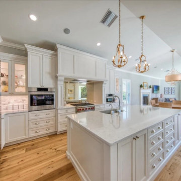 Open White Kitchen With Quartz Island And Connected Living