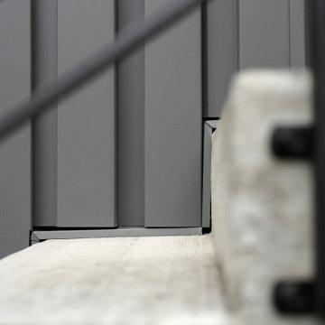 Metal siding lines concrete steps
