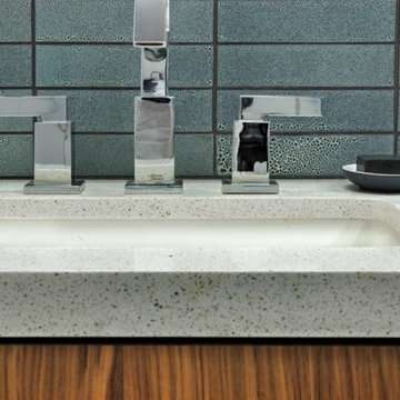 Cool Blue Textured Vanity Backsplash and Speckled Quartz Countertop