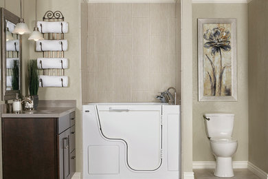 Example of a mid-sized transitional beige tile single-sink bathroom design in Columbus with flat-panel cabinets, brown cabinets, a one-piece toilet, an integrated sink, solid surface countertops, gray countertops and a built-in vanity