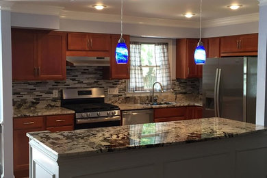 Example of a large transitional l-shaped ceramic tile and beige floor eat-in kitchen design in DC Metro with an undermount sink, recessed-panel cabinets, medium tone wood cabinets, granite countertops, multicolored backsplash, glass tile backsplash, stainless steel appliances and an island