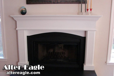 Example of a transitional living room design in San Francisco with a standard fireplace and a wood fireplace surround