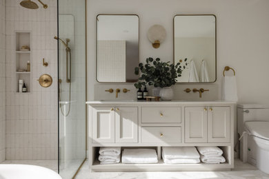 Bathroom - transitional white tile and ceramic tile marble floor, white floor and double-sink bathroom idea in Toronto with shaker cabinets, beige cabinets, a bidet, beige walls, an undermount sink, quartz countertops, white countertops and a freestanding vanity