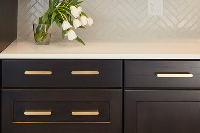 Example of a mid-sized transitional l-shaped medium tone wood floor and brown floor eat-in kitchen design in Chicago with an undermount sink, shaker cabinets, dark wood cabinets, quartz countertops, white backsplash, ceramic backsplash, paneled appliances and an island