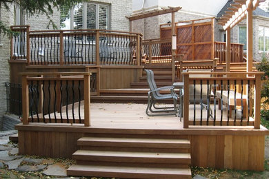 Photo of a mid-sized traditional patio in Toronto with decking and a pergola.