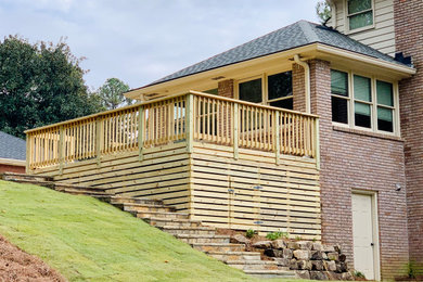 Example of a large classic backyard deck design in Atlanta