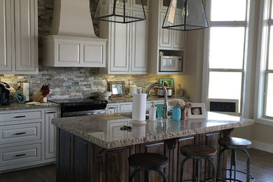 Mid-sized arts and crafts l-shaped dark wood floor open concept kitchen photo in Other with an undermount sink, raised-panel cabinets, white cabinets, granite countertops, multicolored backsplash, stone tile backsplash, stainless steel appliances and an island