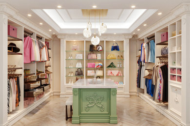 Inspiration for a large timeless women's coffered ceiling walk-in closet remodel in Los Angeles with recessed-panel cabinets and white cabinets