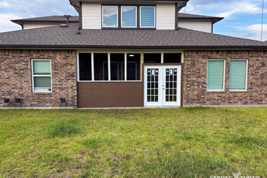 Example of a mid-sized backyard patio design in Houston with a roof extension