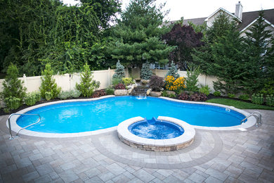 Island style pool photo in New York