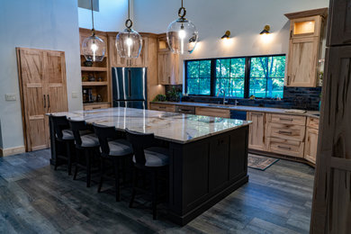 Eat-in kitchen - huge southwestern porcelain tile and vaulted ceiling eat-in kitchen idea in Other with an undermount sink, recessed-panel cabinets, light wood cabinets, granite countertops, porcelain backsplash, stainless steel appliances and an island